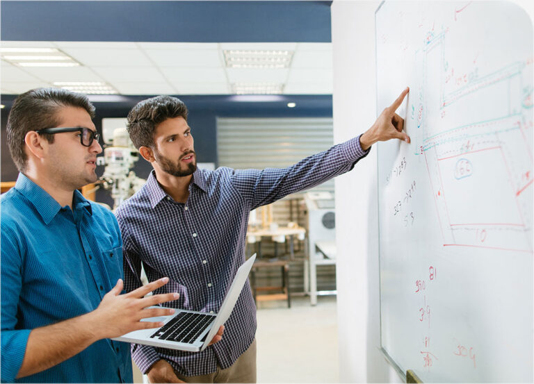 man pointing as a diagram on a whiteboard