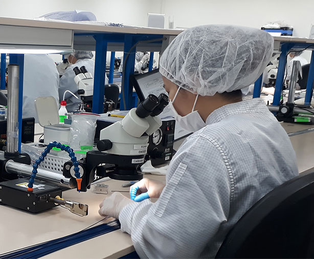 scientist looking through a microscope