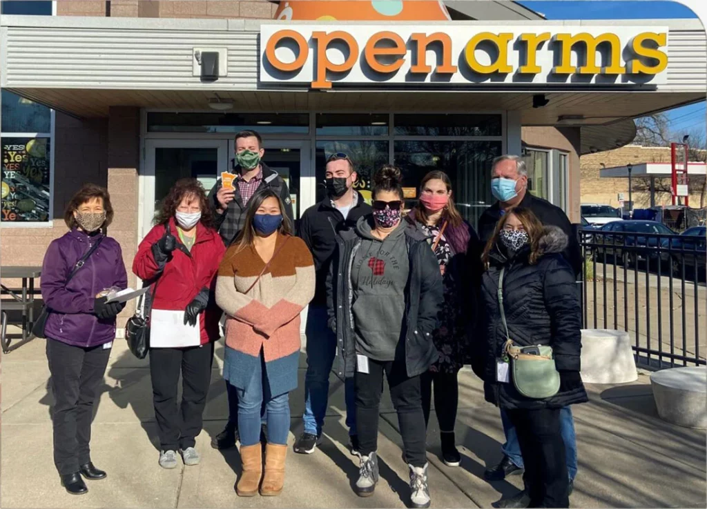 Intricon Team in front of a store called "Open Arms"