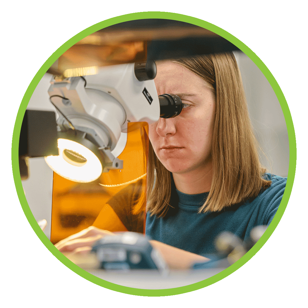 Resources-PageReources-Header Person looking through microscope